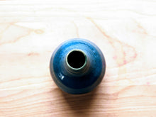 Load image into Gallery viewer, Top shot of blue bud vase on top of a butcher block counter.
